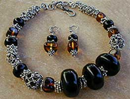 Jet, Amber, and Sterling Silver necklace, bracelet and earrings by Vicky Jousan